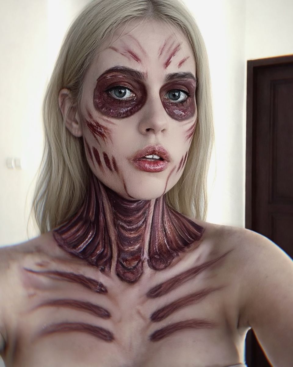 Creature makeup: hollowed eyes, slashes and raised ribcage ridges painted across neck and chest