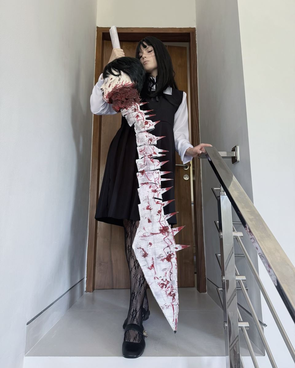 Anime character cosplay with a built bloodied blade arm