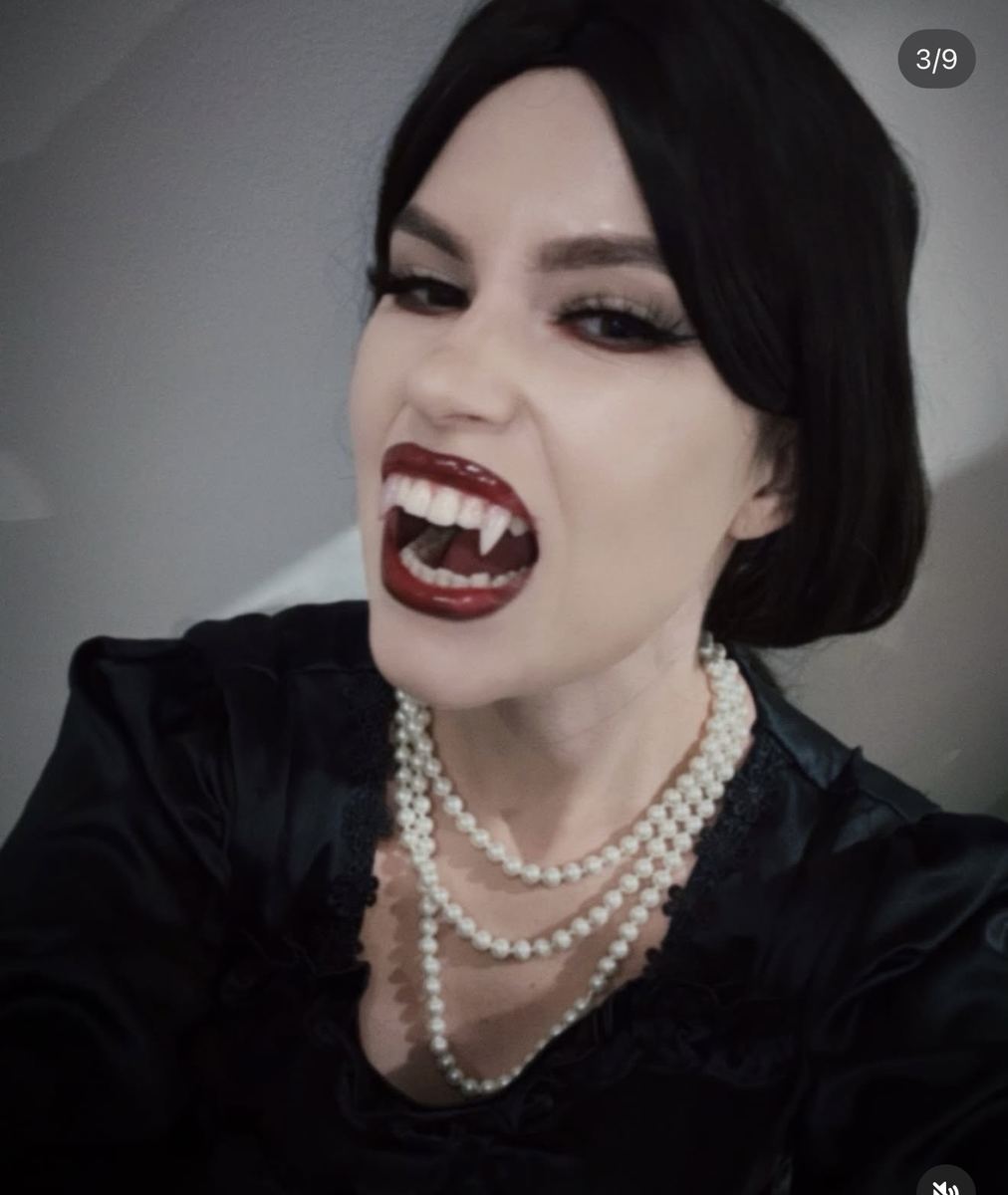Vampire character with custom fangs and dark red lip